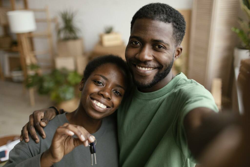 smiley-couple-taking-selfie-their-new-home